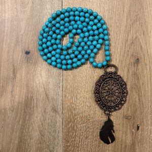 Turquoise beaded necklace with bronze accent/feather